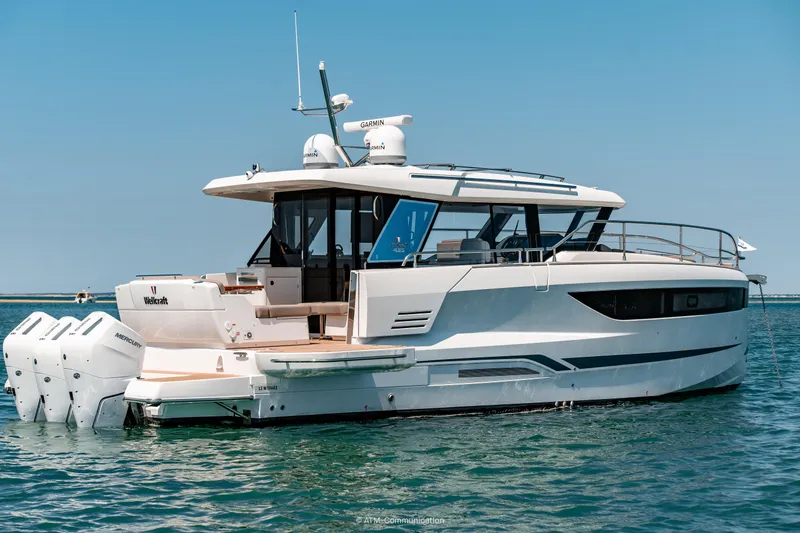 Slide: The Image of 2026 Wellcraft 44 Explorer yacht on calm blue water, rear view. - 19