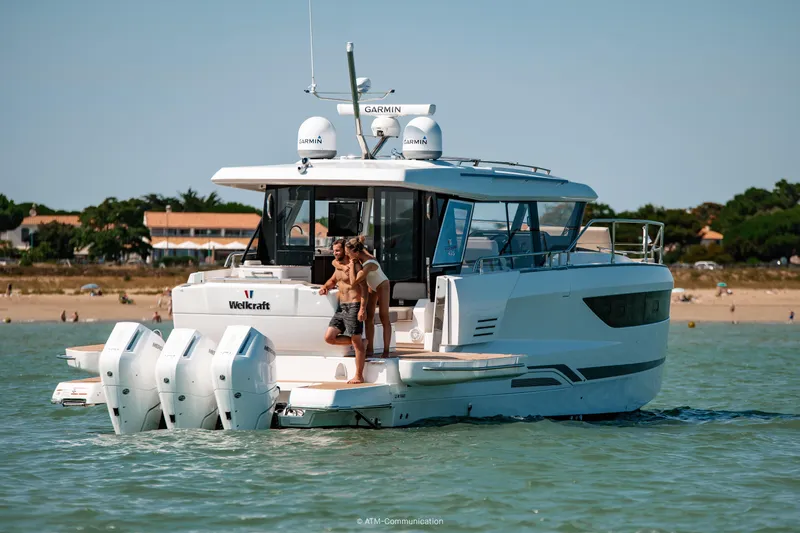 Slide: The Image of 2026 Wellcraft 44 Explorer yacht on water, featuring multiple outboard engines. - 15