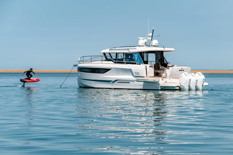 Slide: The Image of 2026 Wellcraft 44 Explorer yacht on water with person on hydrofoil nearby. - 17