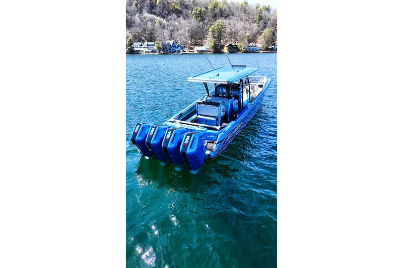 Slide: The Image of 2026 Nor-Tech 390 Sport boat with multiple engines on a serene lake. - 8