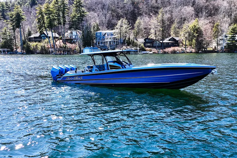 Slide: The Image of 2026 Nor-Tech 390 Sport boat on a scenic lake with forested shoreline. - 3