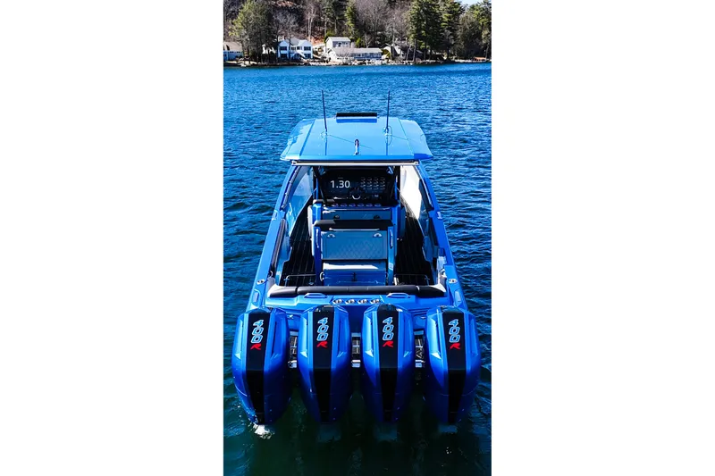 Slide: The Image of 2026 Nor-Tech 390 Sport boat with quad 400R engines on a serene lake. - 7