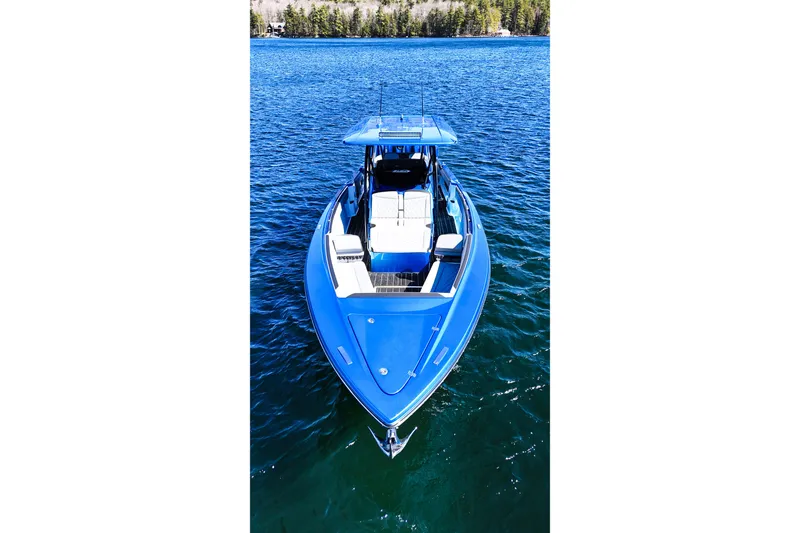 Slide: The Image of 2026 Nor-Tech 390 Sport boat in vibrant blue on clear water. - 5
