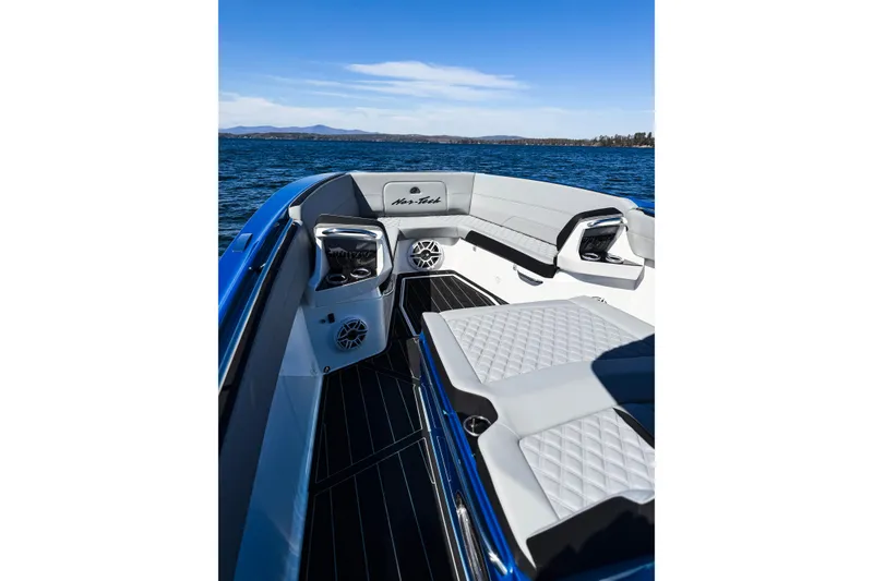 Slide: The Image of 2026 Nor-Tech 390 Sport boat interior with luxurious seating on a serene lake. - 14