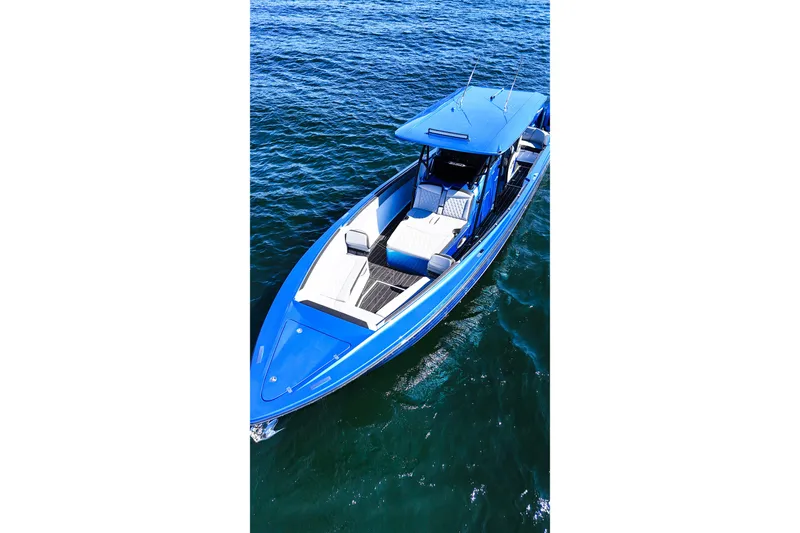 Slide: The Image of 2026 Nor-Tech 390 Sport boat in blue, cruising on open water. - 10