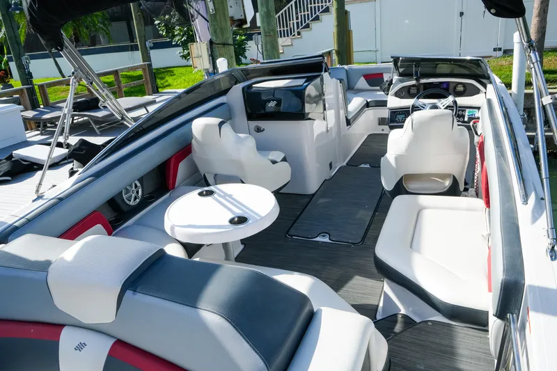 Slide: The Image of 2018 Four Winns HD240 OB boat interior with spacious seating and modern dashboard. - 13