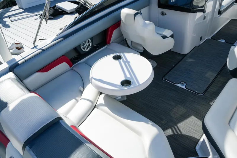 Slide: The Image of 2018 Four Winns HD240 OB boat interior with seating and round table. - 14