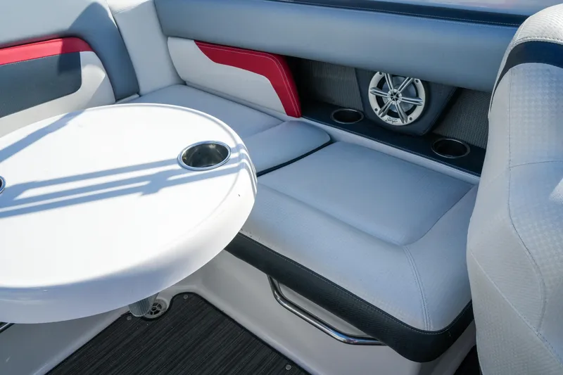 Slide: The Image of 2018 Four Winns HD240 OB boat interior with seating, table, and speaker system. - 38