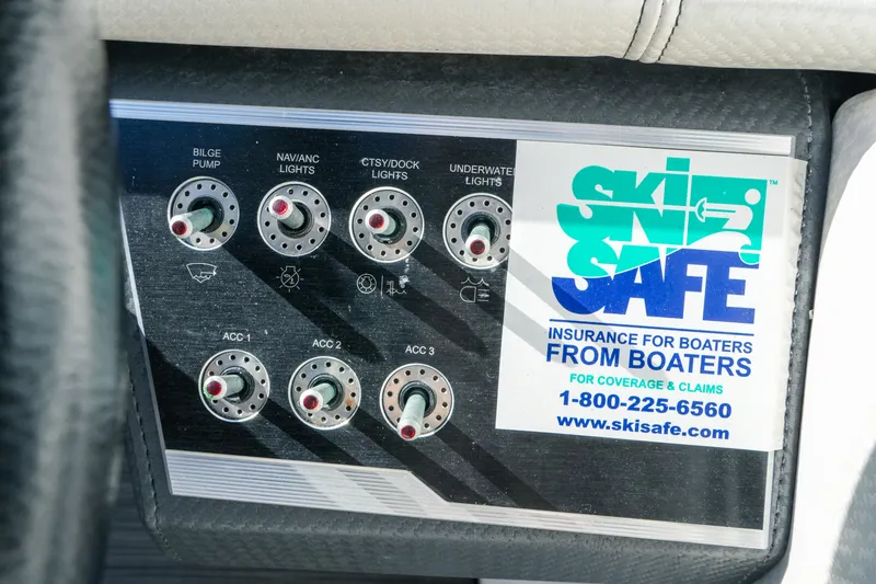 Slide: The Image of Control panel of a 2018 Four Winns HD240 OB boat with Ski Safe insurance sticker. - 42