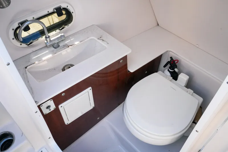 Slide: The Image of 2018 Four Winns HD240 OB boat bathroom with sink and toilet. - 44