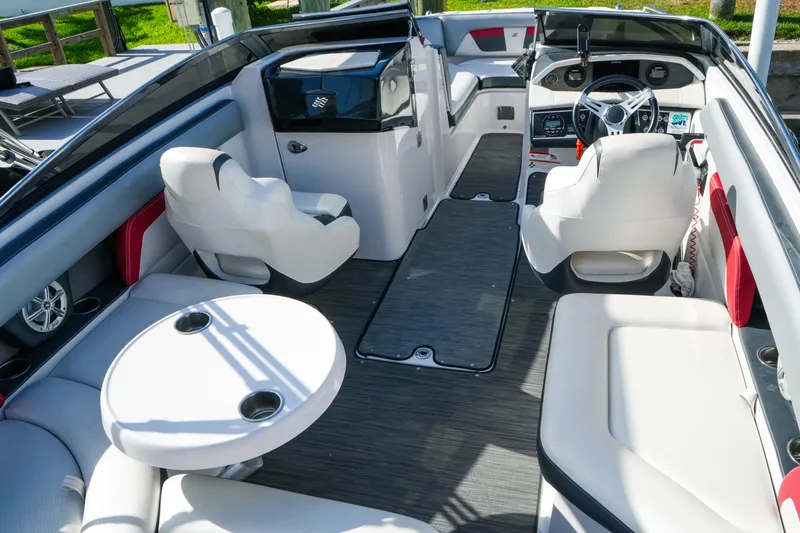 Slide: The Image of Interior of 2018 Four Winns HD240 OB boat with white seating and modern dashboard. - 15