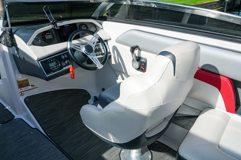 Slide: The Image of 2018 Four Winns HD240 OB boat interior with steering wheel and captain's seat. - 18