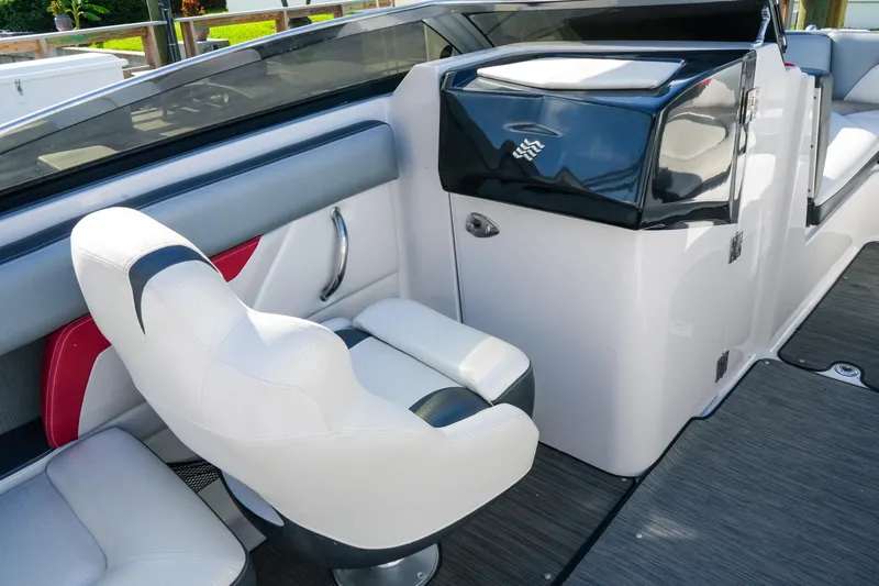 Slide: The Image of 2018 Four Winns HD240 OB boat interior with white seating and sleek design. - 16