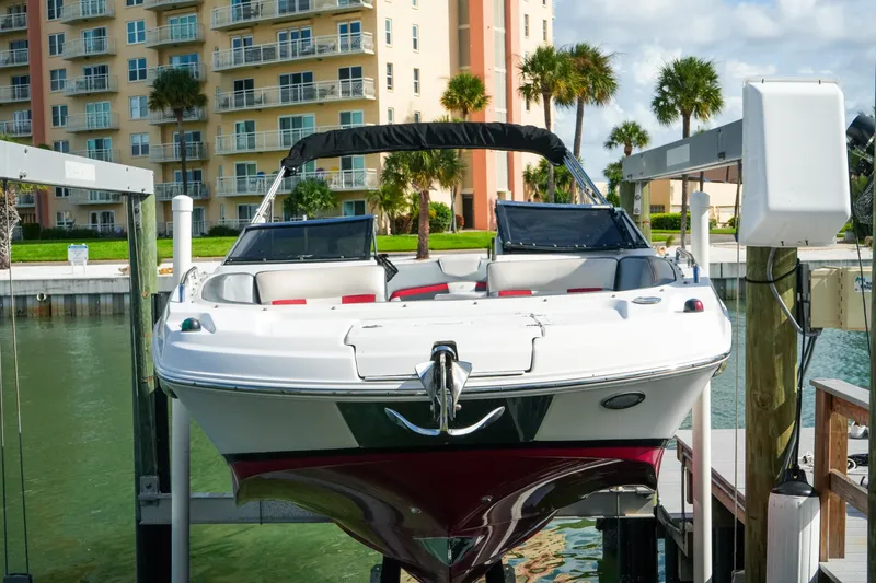 Slide: The Image of 2018 Four Winns HD240 OB boat docked near waterfront apartments. - 53
