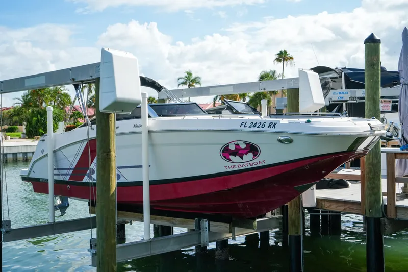 Slide: The Image of 2018 Four Winns HD240 OB boat named "The Batboat" docked on a lift. - 51