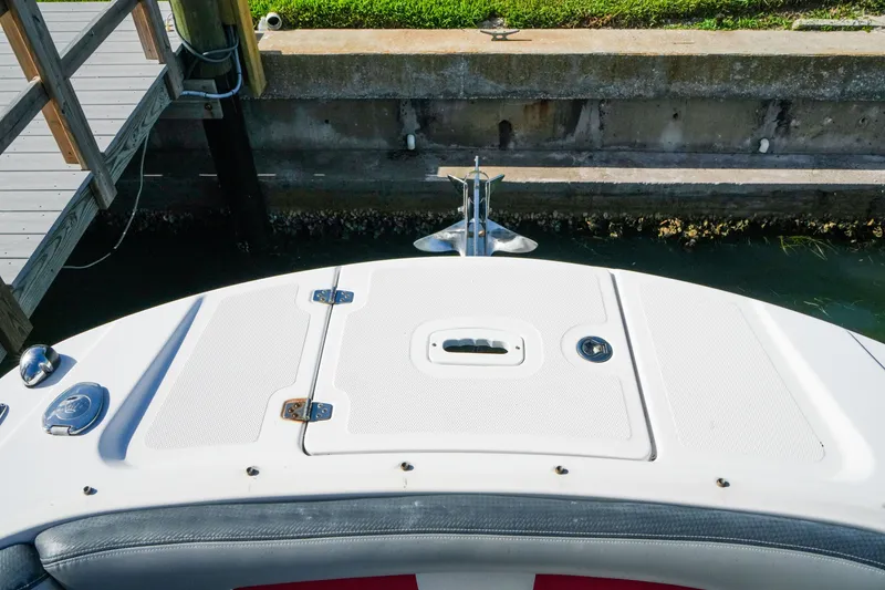 Slide: The Image of 2018 Four Winns HD240 OB boat bow with anchor near dock. - 27