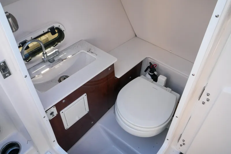 Slide: The Image of 2018 Four Winns HD240 OB boat bathroom with sink and toilet. - 43