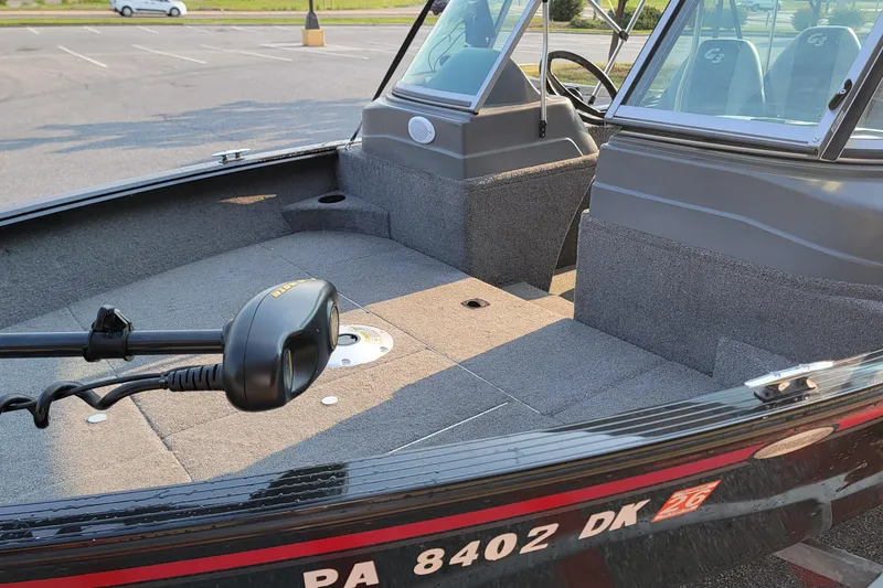 Slide: The Image of 2014 G3 Angler V164 F boat interior with carpeted deck and steering console. - 8