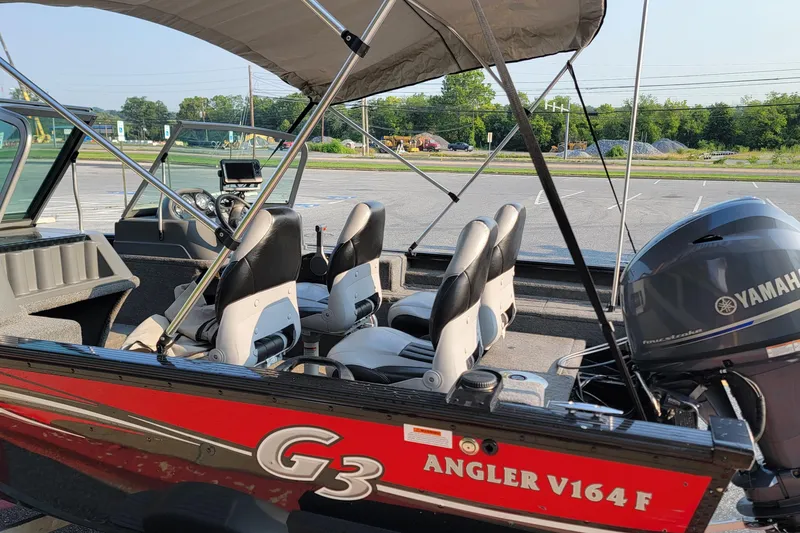 Slide: The Image of 2014 G3 Angler V164 F boat with Yamaha motor, parked outdoors. - 10