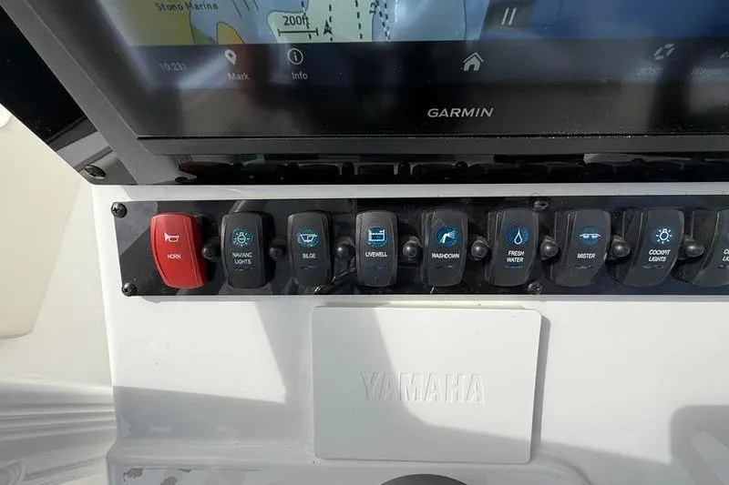 Slide: The Image of Control panel of a 2022 Sea Hunt Ultra 234 boat with Garmin display and Yamaha branding. - 17