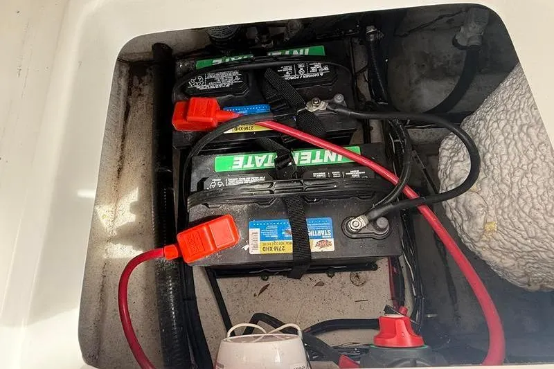 Slide: The Image of Battery compartment of a 2022 Sea Hunt Ultra 234 boat with cables and connectors. - 4