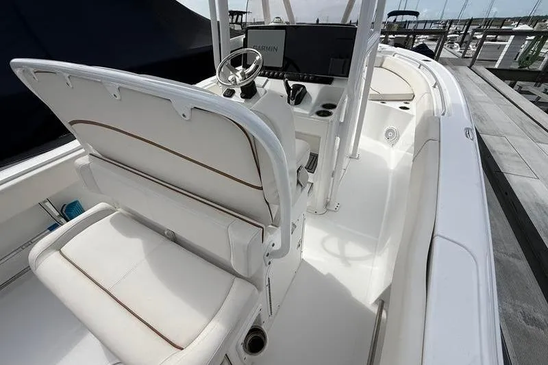 Slide: The Image of 2022 Sea Hunt Ultra 234 boat interior with steering wheel and seating. - 9