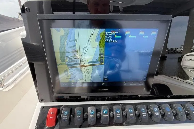 Slide: The Image of Garmin navigation display on 2022 Sea Hunt Ultra 234 boat dashboard with control panel. - 14