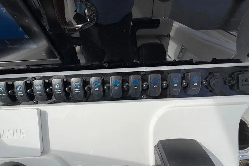 Slide: The Image of Control panel of a 2022 Sea Hunt Ultra 234 boat with labeled switches. - 18