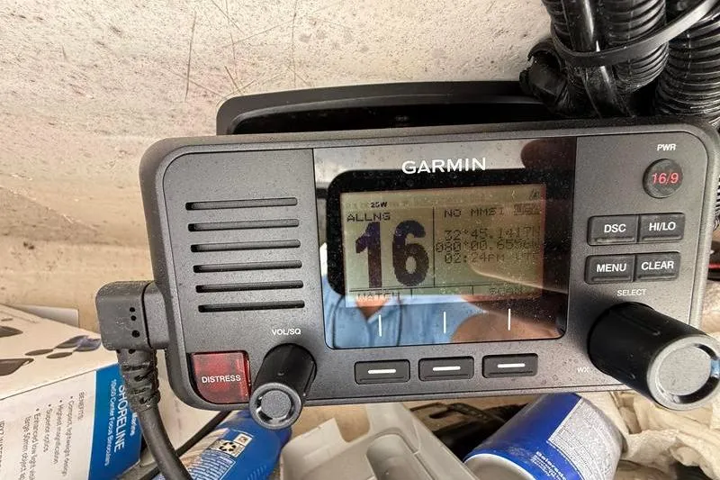 Slide: The Image of Garmin marine radio on a 2022 Sea Hunt Ultra 234 boat dashboard. - 19