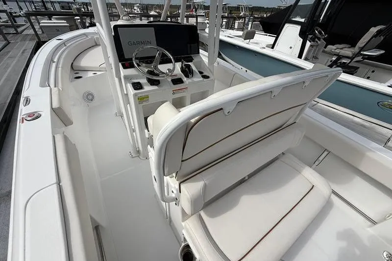 Slide: The Image of 2022 Sea Hunt Ultra 234 boat interior with Garmin navigation system and white seating. - 8