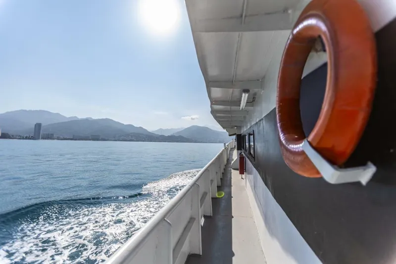 Slide: The Image of A 1983 passenger ferry travels on calm waters with mountains in the background. - 3