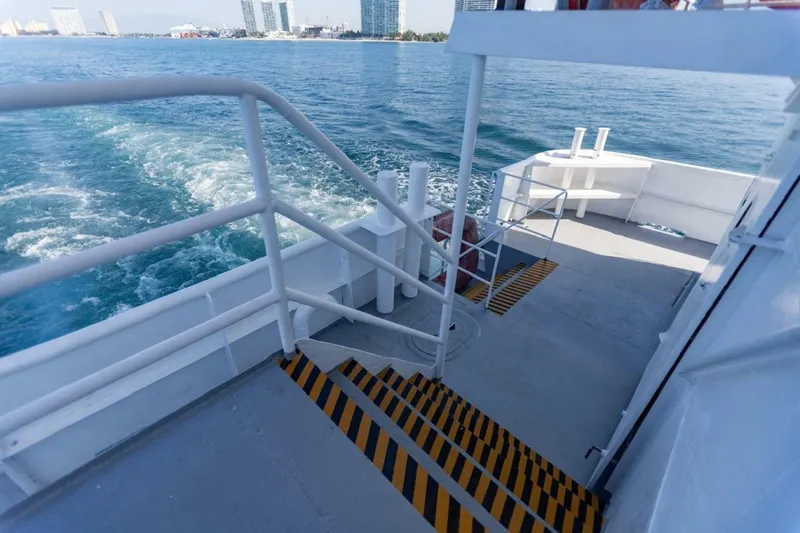 Slide: The Image of A passenger ferry with stairs and railings leading to the water. Buildings are visible in the background. - 5