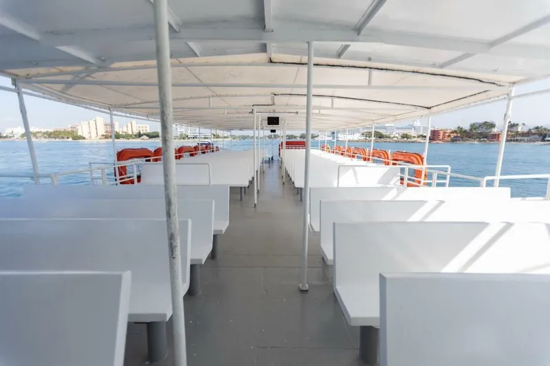 Slide: The Image of A passenger ferry with white benches and lifebuoys on the sides, on calm water. - 10