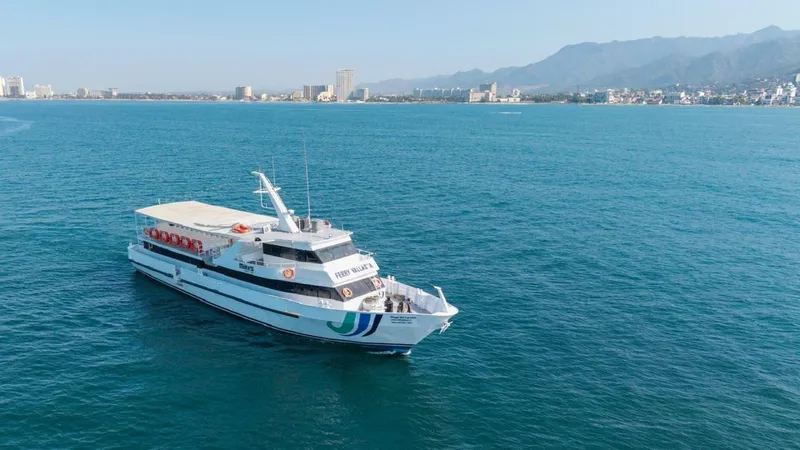 Slide: The Image of A white passenger ferry with blue stripes sails on calm waters, with a city in the background. - 4