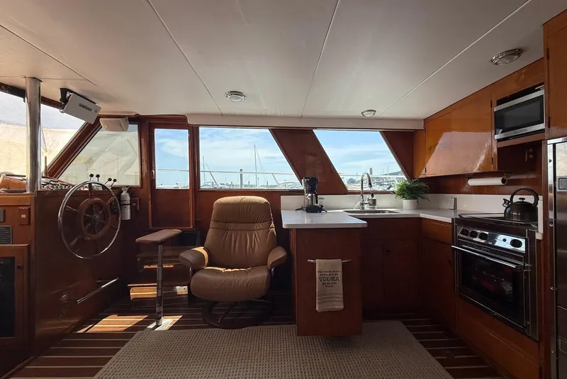 Slide: The Image of Interior of 1985 DeFever 40 Offshore Cruiser with helm, kitchen, and seating area. - 31