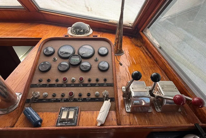 Slide: The Image of 1985 DeFever 40 Offshore Cruiser control panel with gauges and throttle levers. - 36