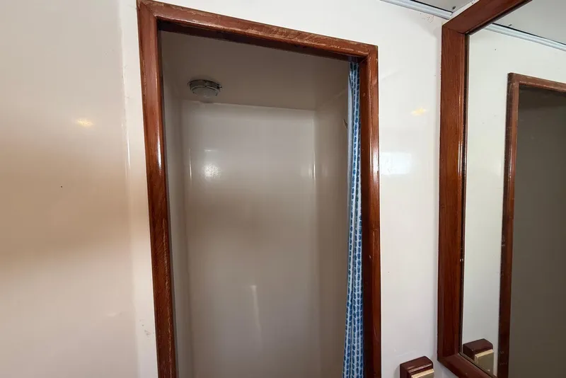 Slide: The Image of Shower area inside 1985 DeFever 40 Offshore Cruiser with wooden trim and curtain. - 28