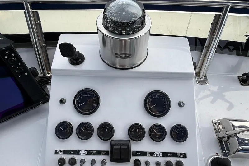 Slide: The Image of Helm controls of a 1985 DeFever 40 Offshore Cruiser with compass and gauges. - 13