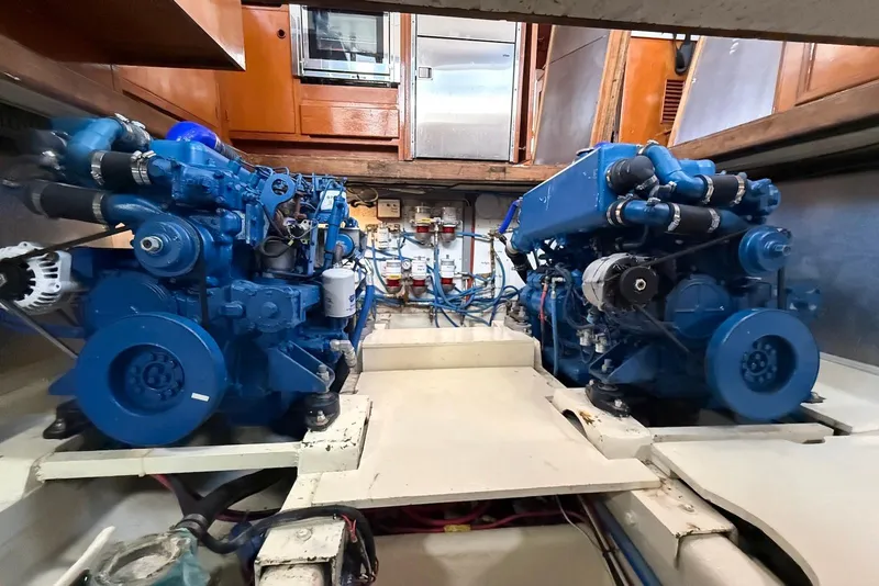 Slide: The Image of Engine room of 1985 DeFever 40 Offshore Cruiser with dual blue marine engines. - 53