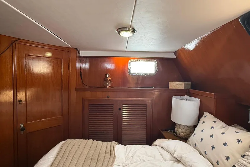 Slide: The Image of Cozy cabin interior of 1985 DeFever 40 Offshore Cruiser with wood paneling and nautical decor. - 26