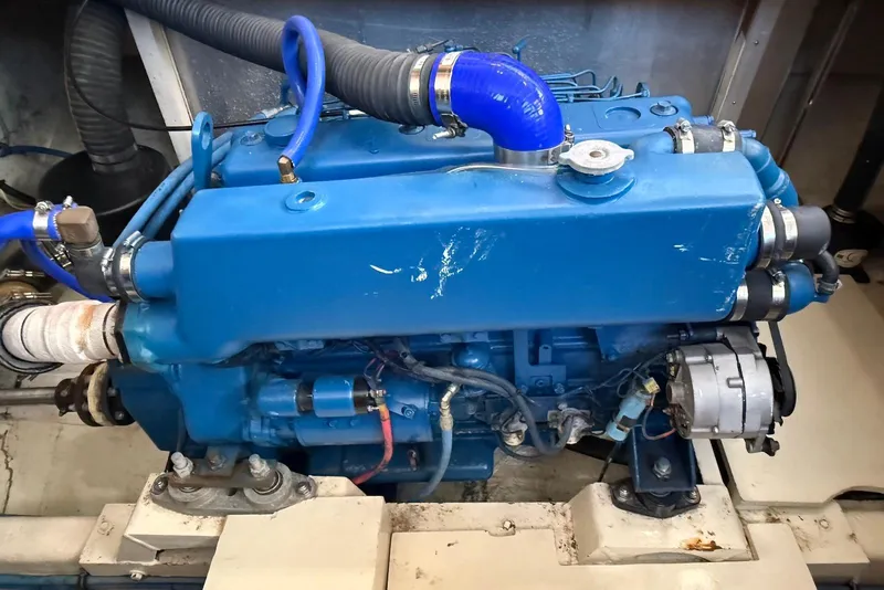 Slide: The Image of Blue engine of a 1985 DeFever 40 Offshore Cruiser with visible hoses and components. - 48