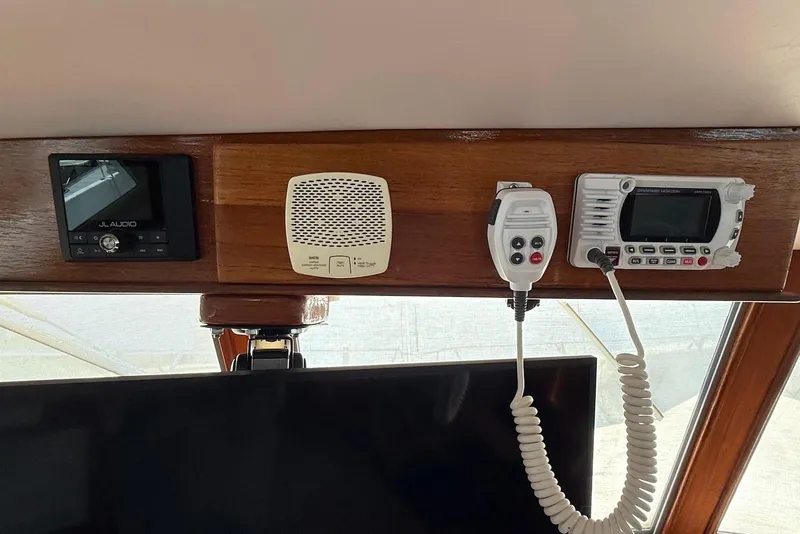 Slide: The Image of Control panel of a 1985 DeFever 40 Offshore Cruiser with audio and communication equipment. - 54