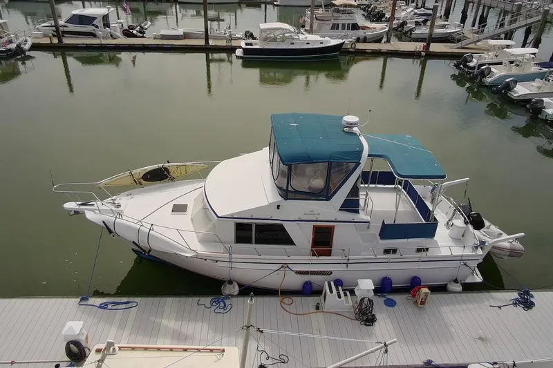 Slide: The Image of 1985 DeFever 40 Offshore Cruiser docked at marina, aerial view. - 4