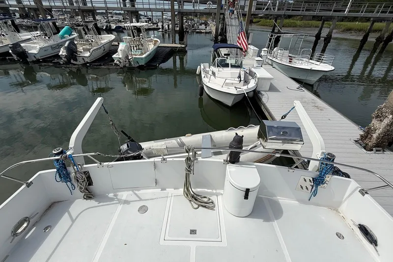 Slide: The Image of 1985 DeFever 40 Offshore Cruiser docked at marina with nearby boats. - 10