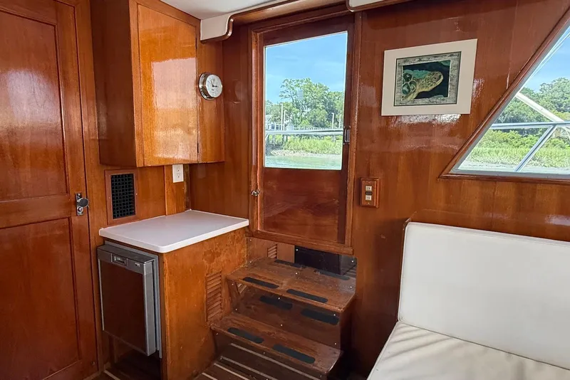 Slide: The Image of Interior of 1985 DeFever 40 Offshore Cruiser with wooden cabinetry and seating. - 33