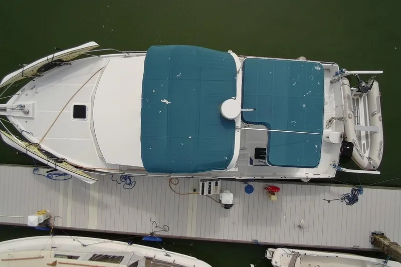 Slide: The Image of Aerial view of 1985 DeFever 40 Offshore Cruiser docked with blue canopy. - 1
