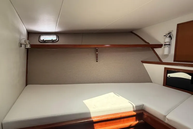 Slide: The Image of 1985 DeFever 40 Offshore Cruiser cabin interior with bed, shelf, and porthole. - 39