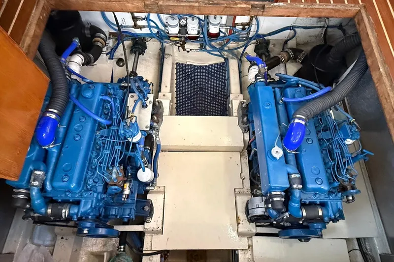 Slide: The Image of Engine room of 1985 DeFever 40 Offshore Cruiser with twin blue marine engines. - 46