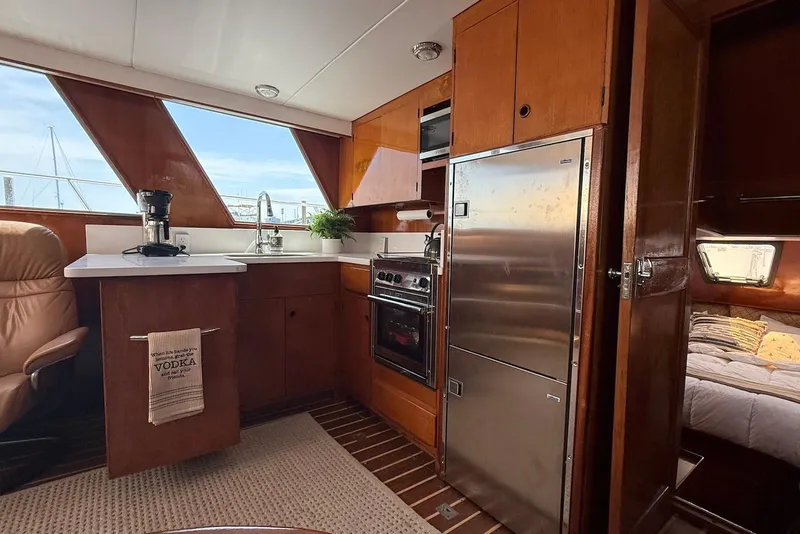 Slide: The Image of Interior of 1985 DeFever 40 Offshore Cruiser with kitchen and cozy cabin view. - 30
