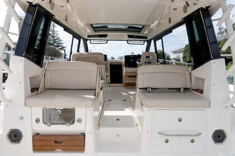Slide: The Image of 2024 Boston Whaler 405 Conquest interior with beige seating and modern design. - 25